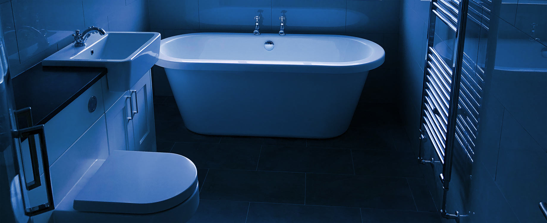 Bathroom with bath, toilet, sink and vertical towel radiator